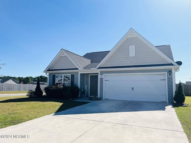 view of front of house featuring a garage and a front lawn