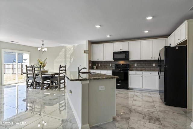 kitchen with marble finish floor, white cabinets, a center island with sink, and black appliances