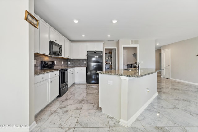 kitchen featuring black appliances, white cabinetry, marble finish floor, and dark stone counters