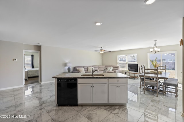 kitchen with marble finish floor, open floor plan, white cabinets, a sink, and dishwasher