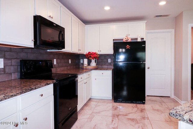 kitchen featuring dark stone countertops, backsplash, black appliances, and white cabinets