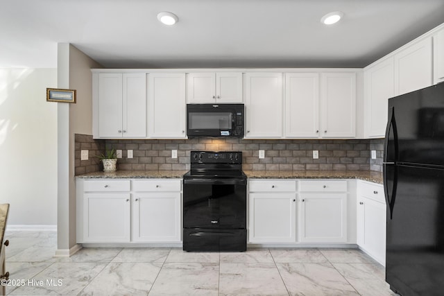 kitchen with marble finish floor, black appliances, dark stone countertops, and white cabinetry