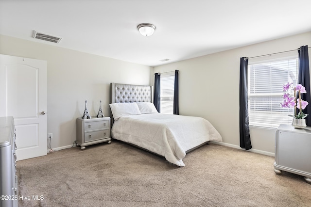 bedroom with visible vents, light carpet, and multiple windows