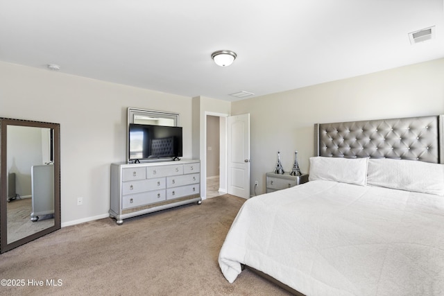 bedroom featuring baseboards, visible vents, and light colored carpet