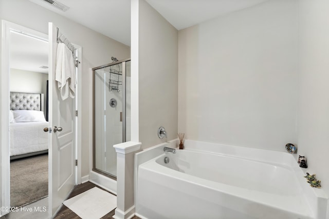 bathroom featuring ensuite bathroom, visible vents, a bath, and a stall shower