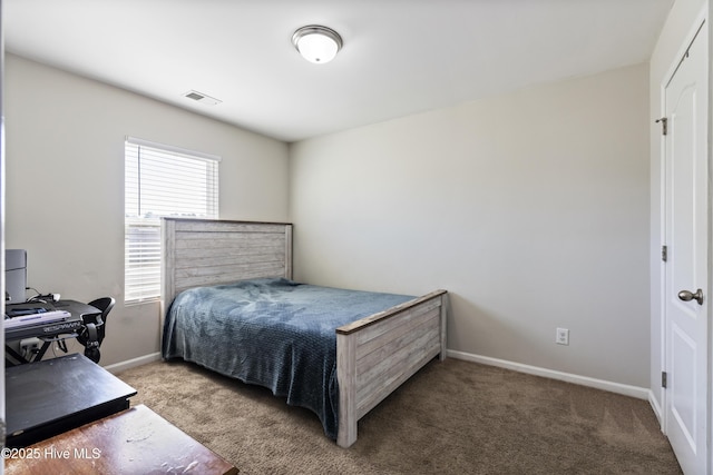 carpeted bedroom featuring visible vents and baseboards