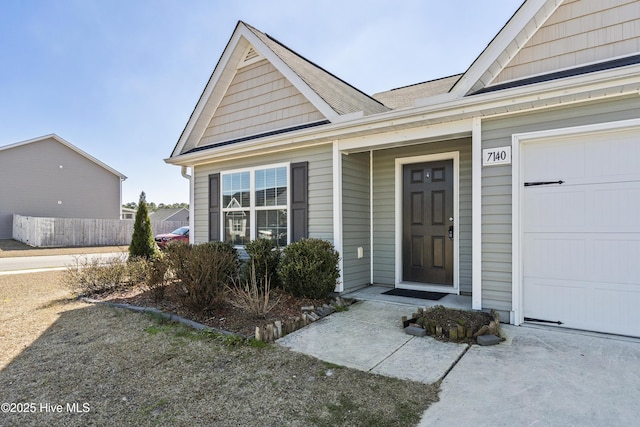 view of exterior entry with a garage