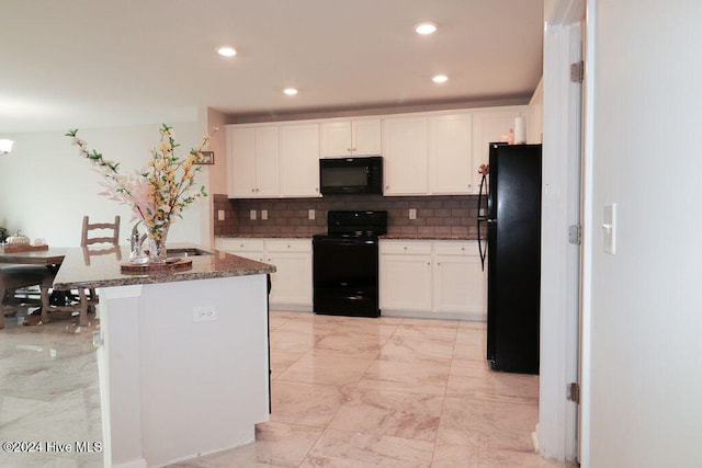 kitchen with dark stone countertops, white cabinetry, tasteful backsplash, and black appliances