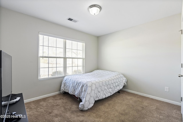 bedroom with carpet, visible vents, and baseboards