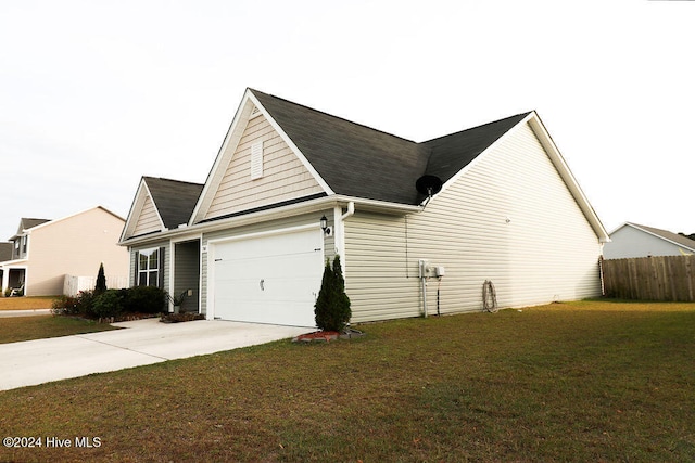 view of home's exterior with a lawn and a garage