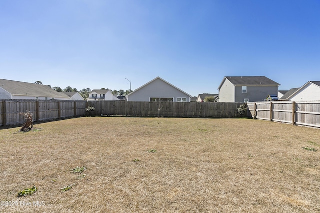 view of yard featuring a residential view and a fenced backyard