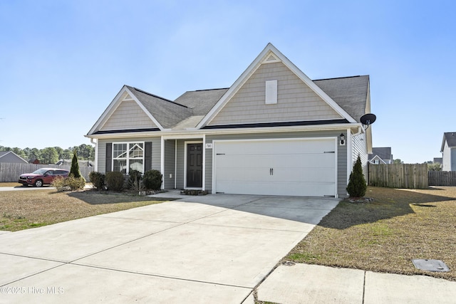 view of front of home featuring a garage, concrete driveway, fence, and a front lawn