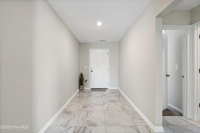 hall featuring marble finish floor, visible vents, and baseboards