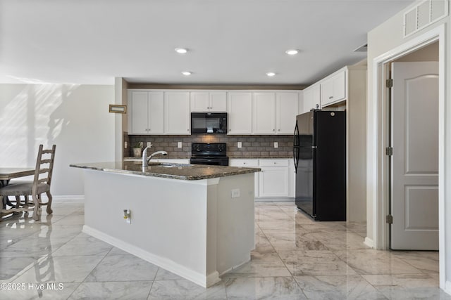 kitchen with visible vents, white cabinets, dark stone counters, marble finish floor, and black appliances