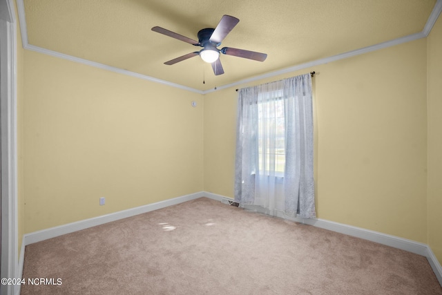 unfurnished room with light carpet, ornamental molding, a textured ceiling, and ceiling fan