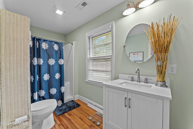 full bathroom with vanity, shower / tub combo, hardwood / wood-style floors, a baseboard heating unit, and toilet