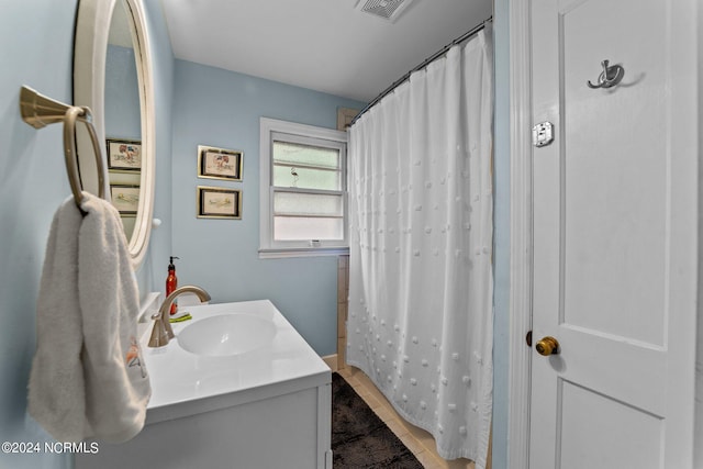 bathroom with vanity, tile patterned flooring, and a shower with curtain