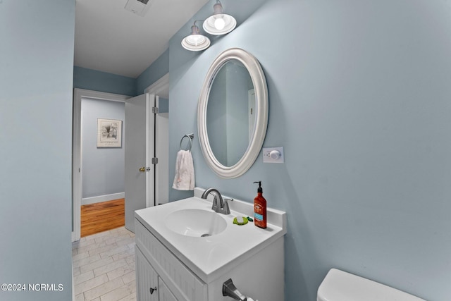 bathroom with vanity, tile patterned floors, and toilet