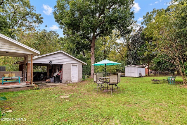 view of yard with a storage shed and a patio area