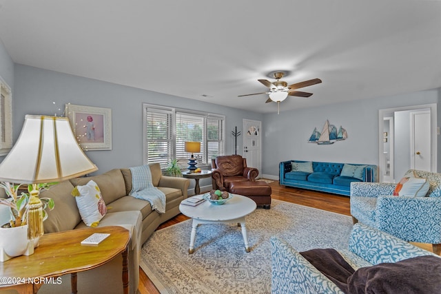 living room featuring hardwood / wood-style floors and ceiling fan