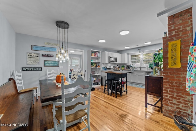 dining area with a chandelier and light hardwood / wood-style flooring