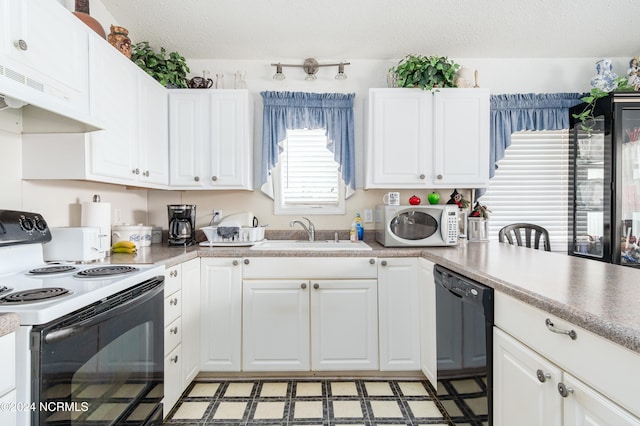 kitchen with white appliances, sink, a textured ceiling, and white cabinetry