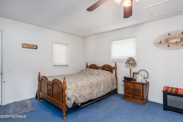 carpeted bedroom featuring a textured ceiling and ceiling fan