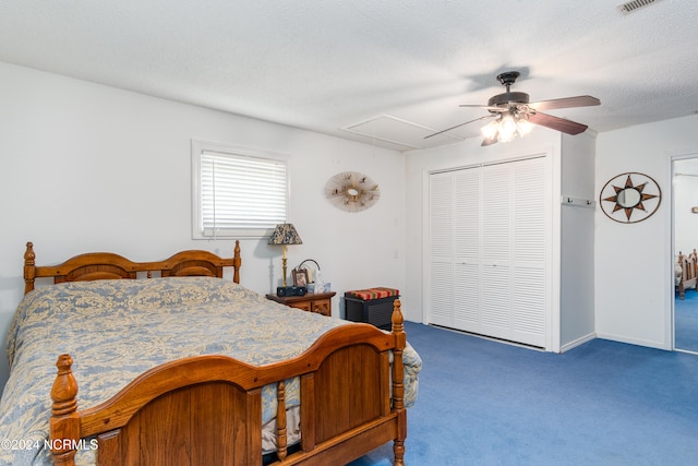 carpeted bedroom featuring a closet, a textured ceiling, and ceiling fan