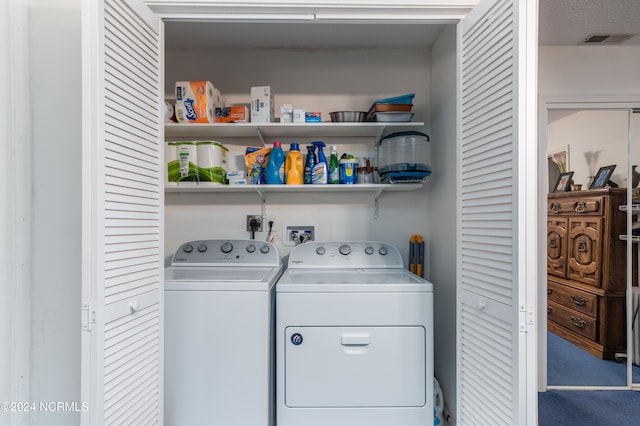 laundry area featuring washing machine and clothes dryer and carpet flooring