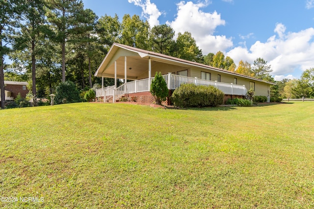 view of side of home featuring a porch and a lawn