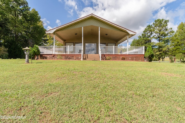 rear view of house featuring a yard and a deck