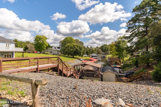 view of property's community with a lawn and a deck