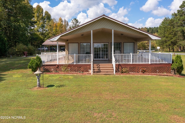 view of front of house with a wooden deck and a front yard