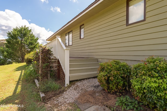 view of property exterior with a yard