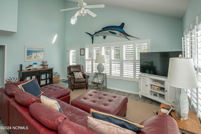 living room featuring lofted ceiling, wood-type flooring, and ceiling fan