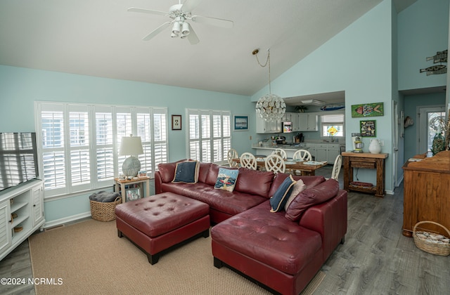 living room with high vaulted ceiling, hardwood / wood-style flooring, and plenty of natural light