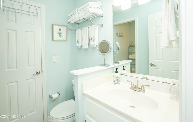 bathroom with vanity and toilet