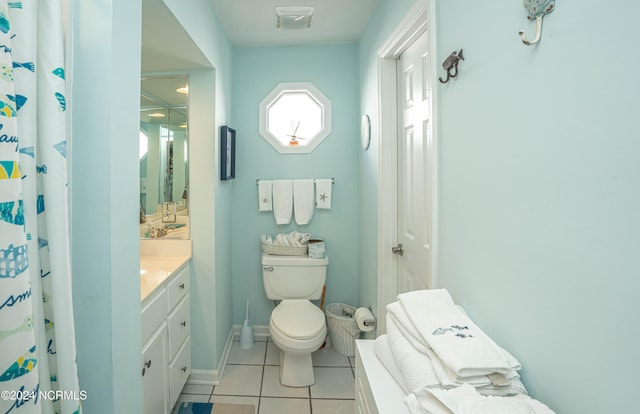 bathroom with vanity, toilet, and tile patterned flooring