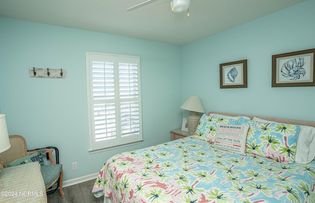 bedroom with dark wood-type flooring and ceiling fan