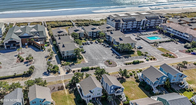 birds eye view of property with a water view and a view of the beach