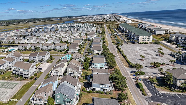 birds eye view of property featuring a water view and a view of the beach