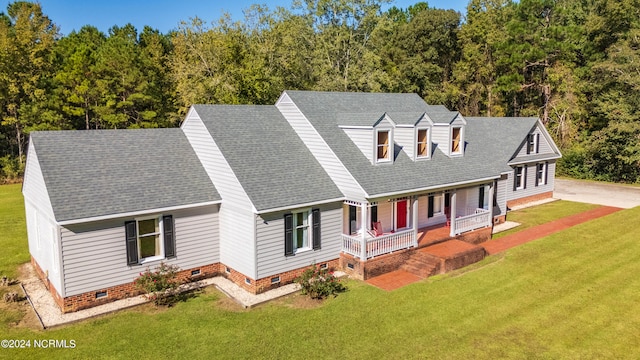 new england style home with a porch and a front yard