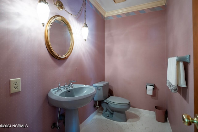 bathroom featuring ornamental molding and toilet