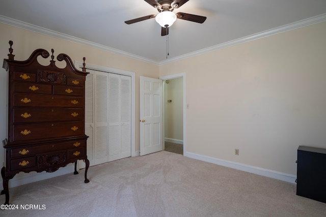 bedroom with a closet, crown molding, light colored carpet, and ceiling fan