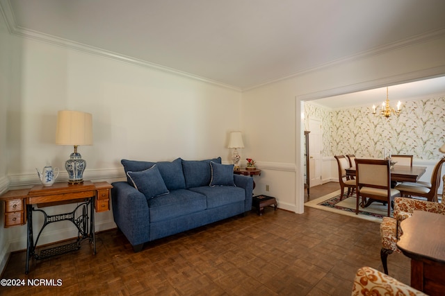 living room with dark parquet floors, crown molding, and an inviting chandelier