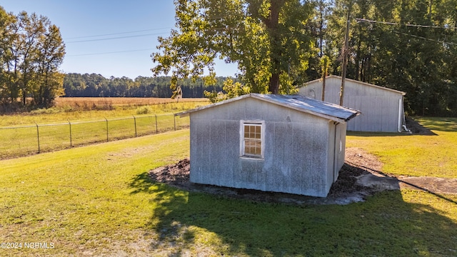 view of outbuilding with a yard