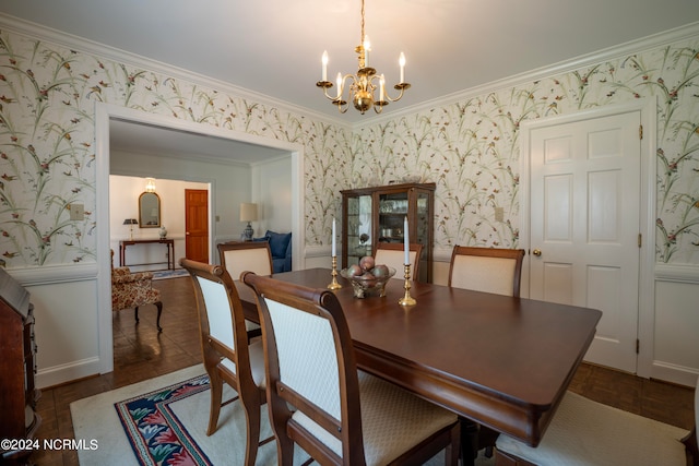 dining space with a notable chandelier and crown molding