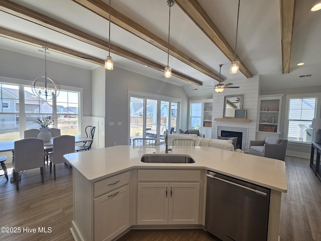 kitchen featuring a sink, open floor plan, dishwasher, and light countertops