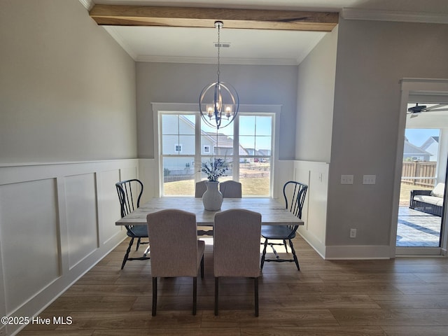 dining area featuring a chandelier, dark wood-type flooring, and a healthy amount of sunlight