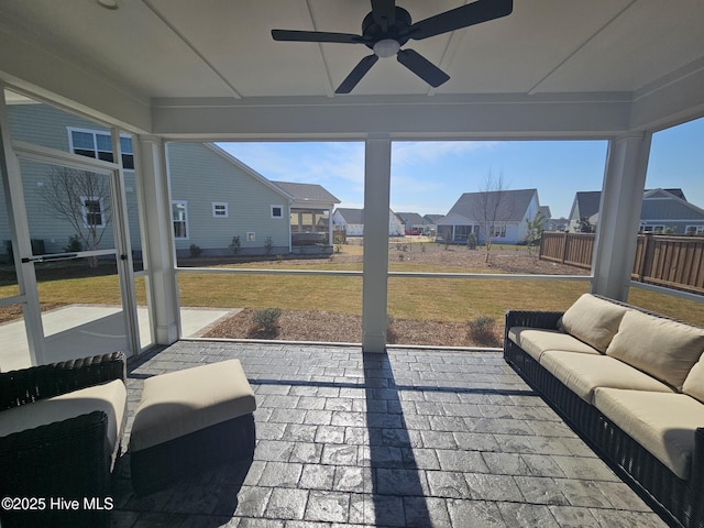 view of patio with a residential view, an outdoor living space, and a ceiling fan